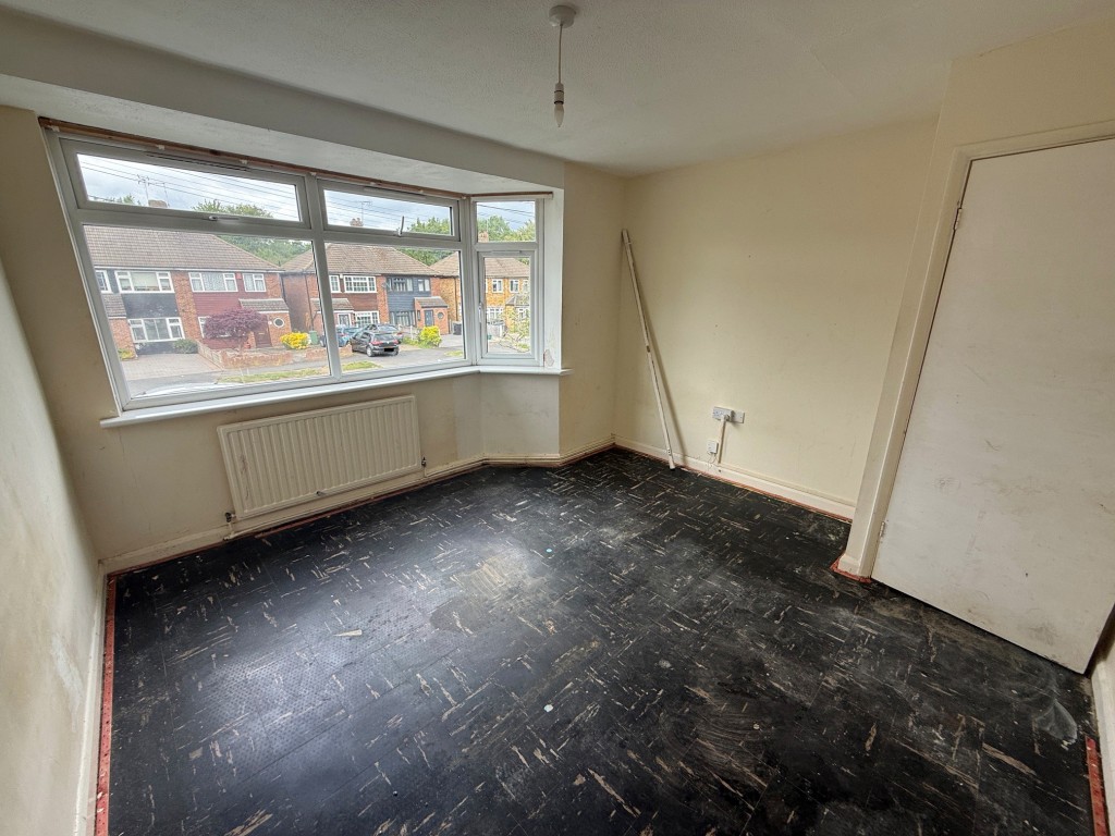 Lot: 23 - TWO-BEDROOM FLAT FOR MODERNISATION - Bedroom with window to front aspect